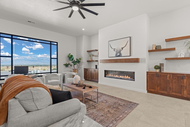 living room with ceiling fan and built in features