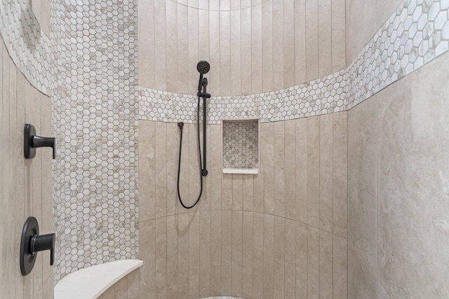 bathroom with a tile shower