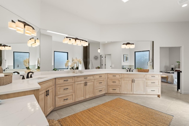 bathroom featuring tile patterned flooring, vanity, and a wealth of natural light