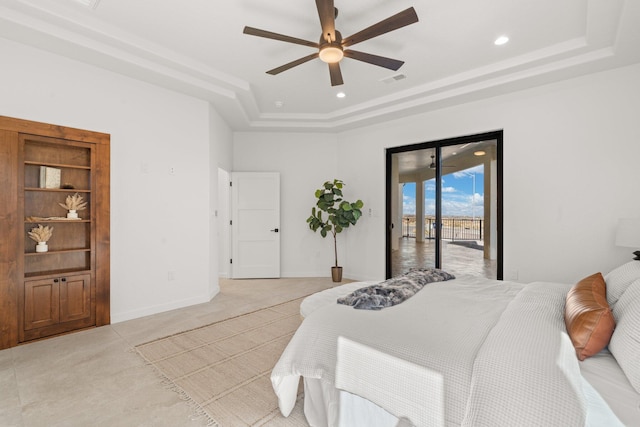 bedroom with a raised ceiling, ceiling fan, and access to exterior