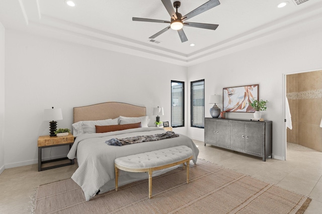 bedroom with a tray ceiling and ceiling fan