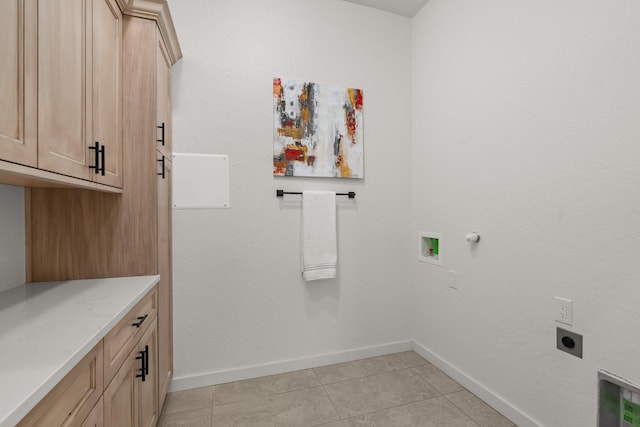 laundry room with hookup for an electric dryer, cabinets, light tile patterned floors, and hookup for a washing machine