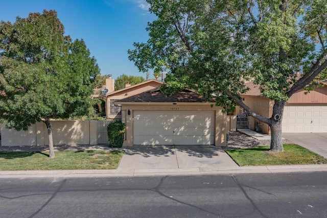 single story home with a garage and a front yard