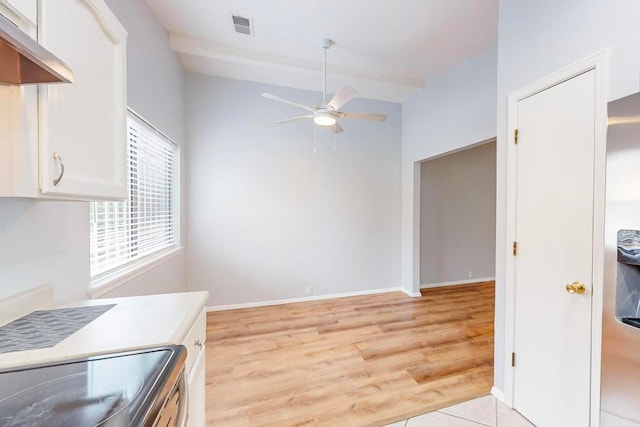 kitchen featuring light hardwood / wood-style floors, ceiling fan, white cabinetry, and stainless steel range oven