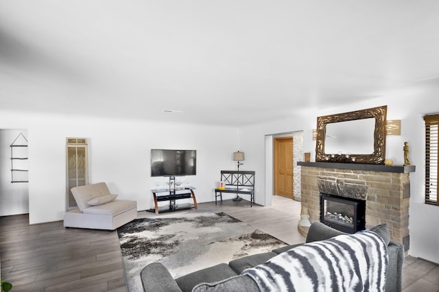 living room with hardwood / wood-style floors and a fireplace