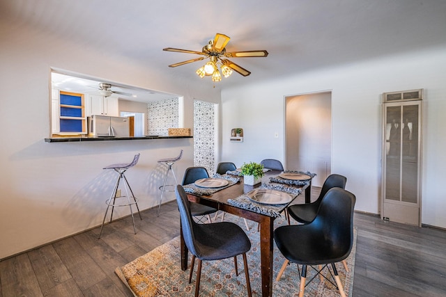 dining room featuring dark wood-type flooring, ceiling fan, and beverage cooler