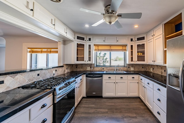 kitchen with dark wood-type flooring, appliances with stainless steel finishes, sink, and white cabinets