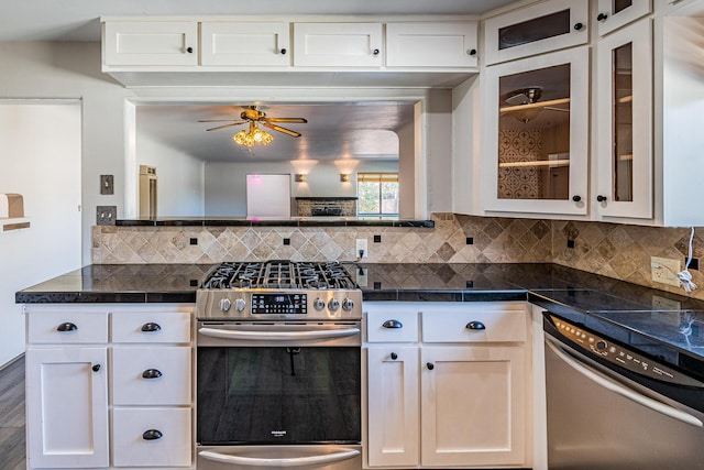 kitchen featuring white cabinetry, appliances with stainless steel finishes, decorative backsplash, and hardwood / wood-style floors