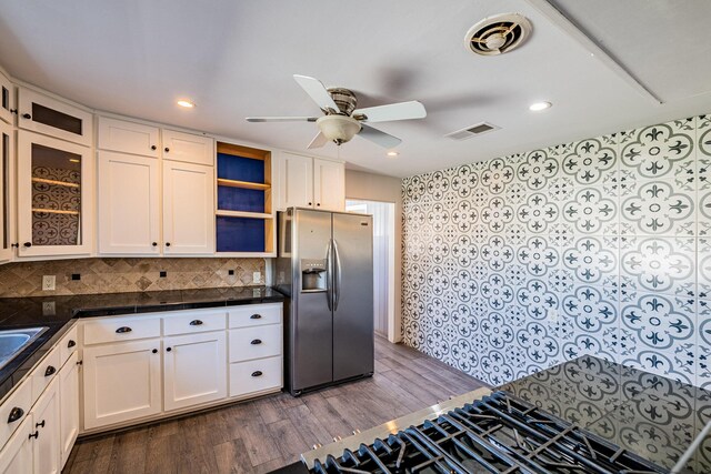 kitchen featuring backsplash, white cabinetry, ceiling fan, dark wood-type flooring, and stainless steel fridge with ice dispenser