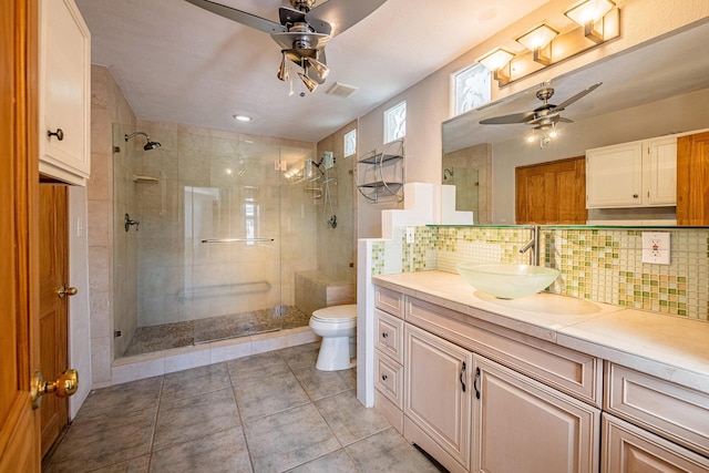 bathroom featuring vanity, decorative backsplash, toilet, and an enclosed shower