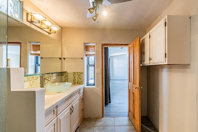 bathroom with vanity, backsplash, wood-type flooring, and a textured ceiling