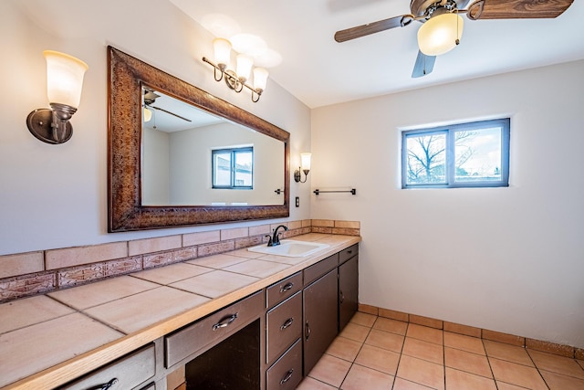 bathroom featuring vanity, a healthy amount of sunlight, ceiling fan, and tile patterned flooring