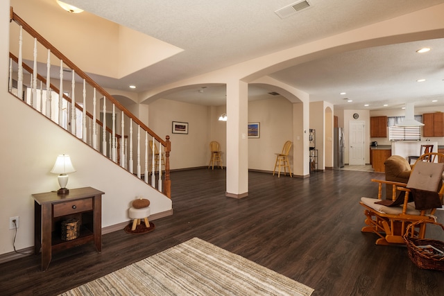 foyer featuring a textured ceiling and dark wood-type flooring