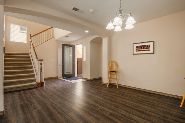 interior space with an inviting chandelier and dark hardwood / wood-style flooring