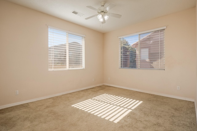 carpeted spare room with ceiling fan