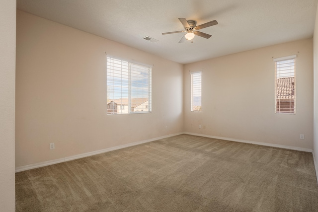 carpeted empty room featuring ceiling fan