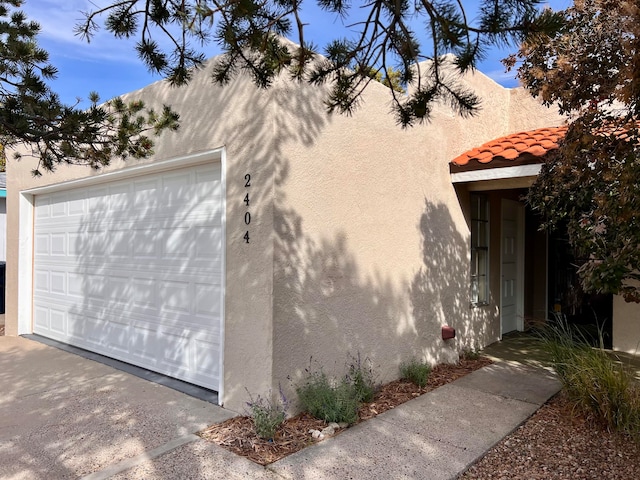 view of front of house with a garage and an outbuilding