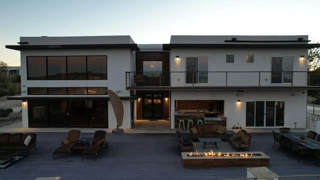 300 Catfish Rd, Elephant Butte, NM 87935 - rear view of property with stucco siding, an outdoor living space with a fire pit, exterior kitchen, and a balcony