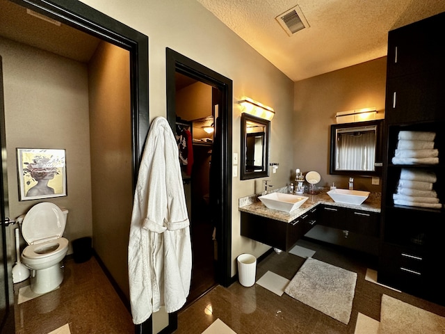 300 Catfish Rd, Elephant Butte, NM 87935 - full bath with visible vents, toilet, a walk in closet, and a sink
