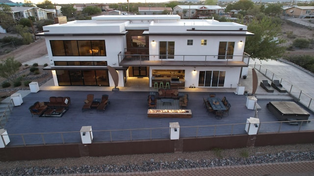 300 Catfish Rd, Elephant Butte, NM 87935 - rear view of house with a fire pit, a balcony, a residential view, and stucco siding
