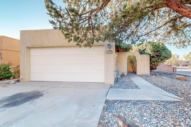 pueblo-style home with a garage