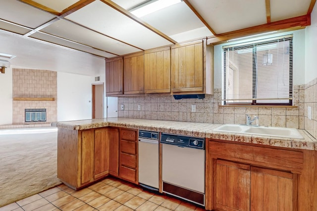 kitchen with tasteful backsplash, sink, light colored carpet, and dishwashing machine