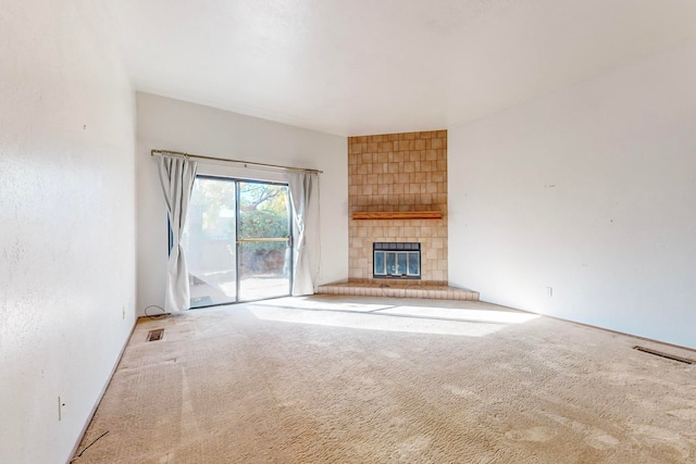 unfurnished living room with a fireplace and carpet flooring