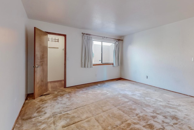 unfurnished bedroom featuring light colored carpet