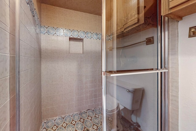 bathroom featuring walk in shower and toilet