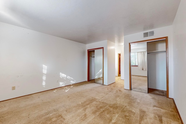 unfurnished bedroom featuring light colored carpet