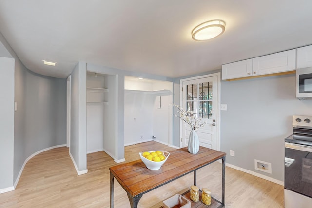 kitchen featuring light hardwood / wood-style flooring, white cabinetry, and stainless steel appliances