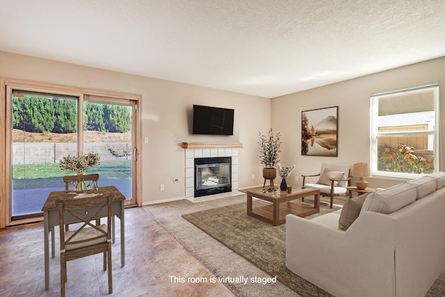 living room featuring a textured ceiling and a fireplace