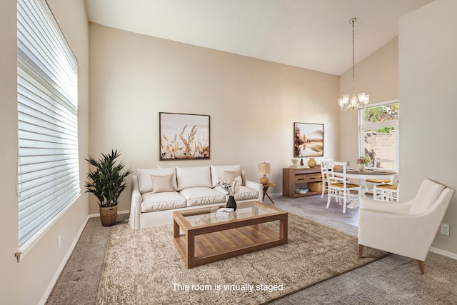 carpeted living room with high vaulted ceiling and a chandelier