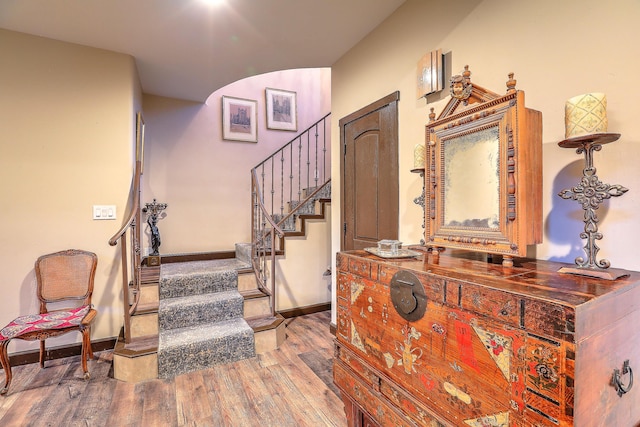 staircase with hardwood / wood-style flooring