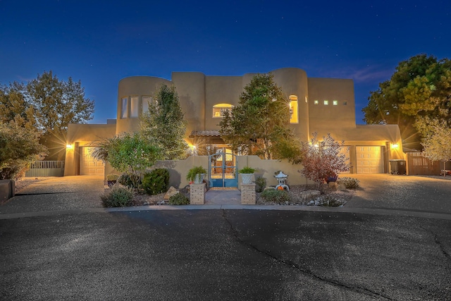 pueblo-style home featuring a garage