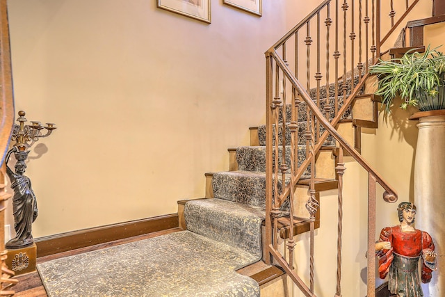 staircase with hardwood / wood-style flooring