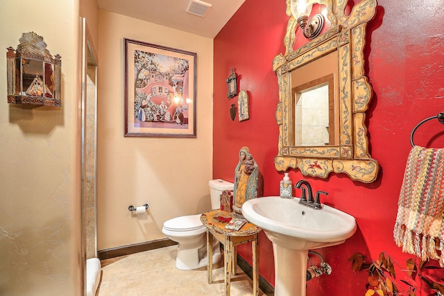 bathroom featuring tile patterned flooring and toilet