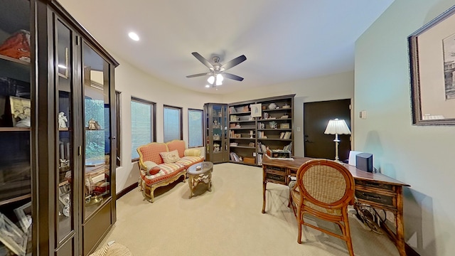 carpeted home office with ceiling fan