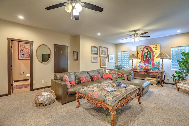 carpeted living room featuring ceiling fan