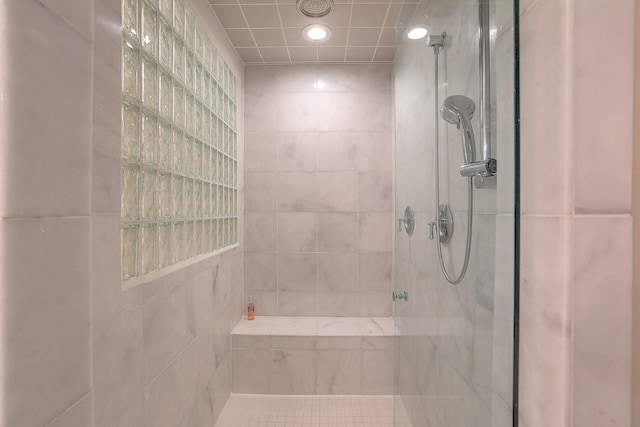 bathroom with a tile shower