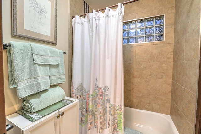 bathroom featuring vanity and shower / bathtub combination with curtain