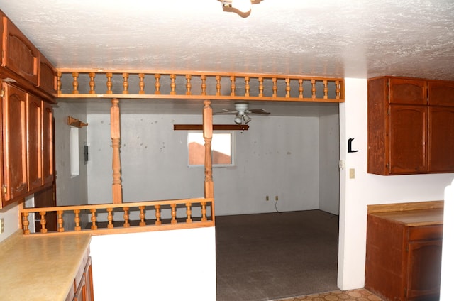 below grade area featuring ceiling fan and a textured ceiling