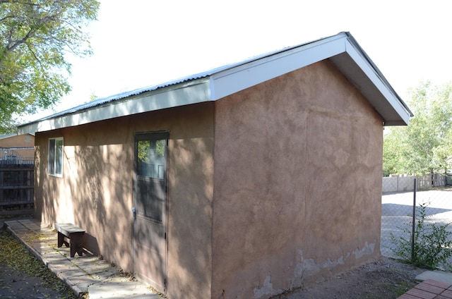 view of property exterior featuring fence and stucco siding