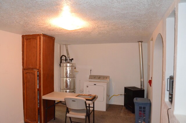 interior space with carpet floors, gas water heater, washer / clothes dryer, and a textured ceiling