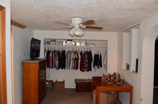 bedroom with arched walkways, a closet, ceiling fan, and a textured ceiling