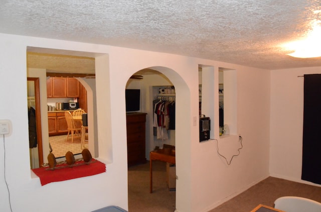 interior space with a textured ceiling and carpet