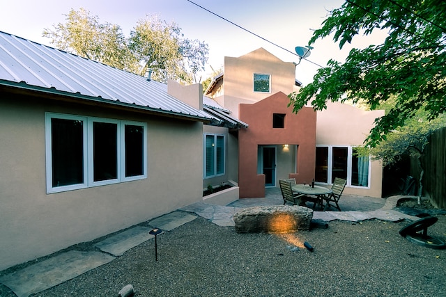 back of house with a patio