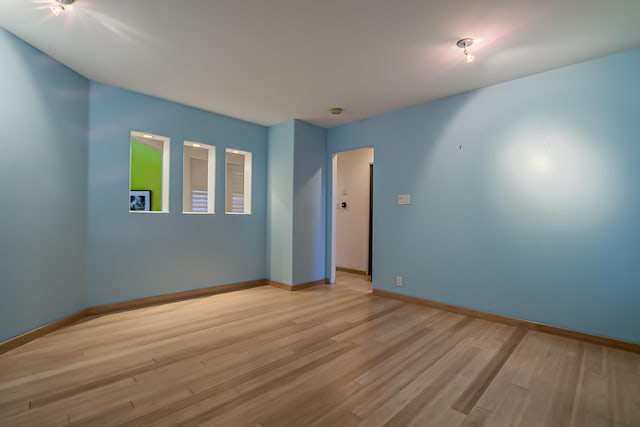 unfurnished room with light hardwood / wood-style flooring