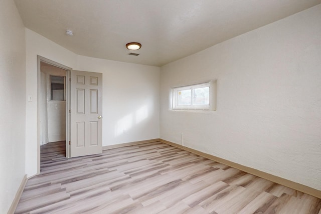 unfurnished room featuring light hardwood / wood-style flooring