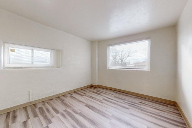 unfurnished room with light hardwood / wood-style floors